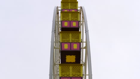 carnival ferris wheel ride turning slowly on a winters day empty