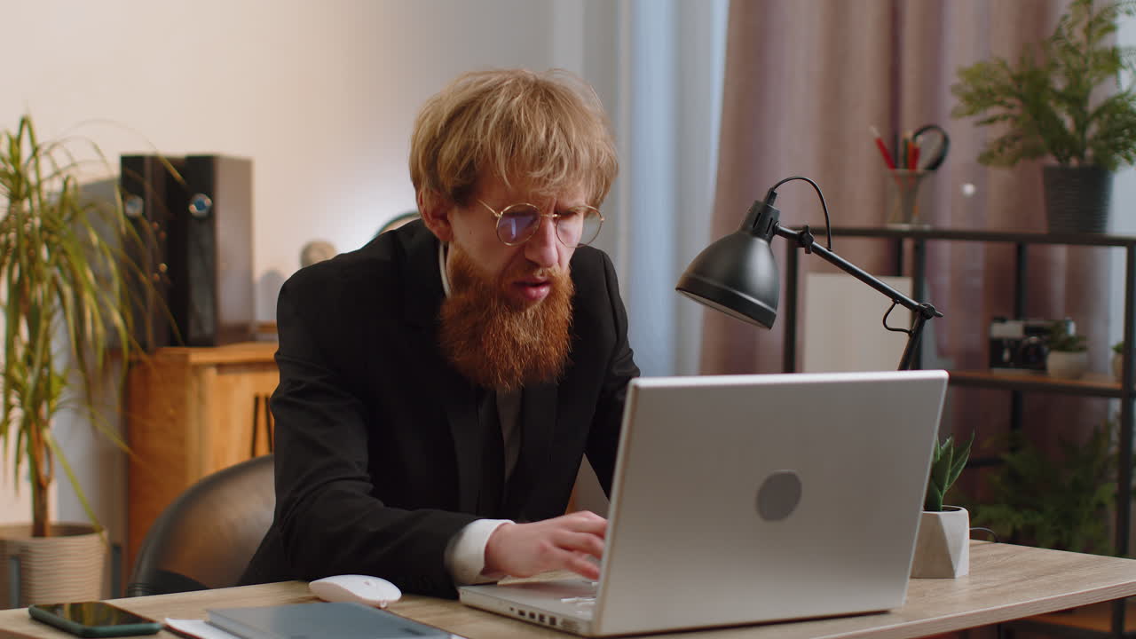 Irritated shocked businessman working on laptop website problem computer virus data loss by hacking