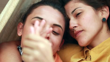 lesbian couple joining hands caressing and cuddling