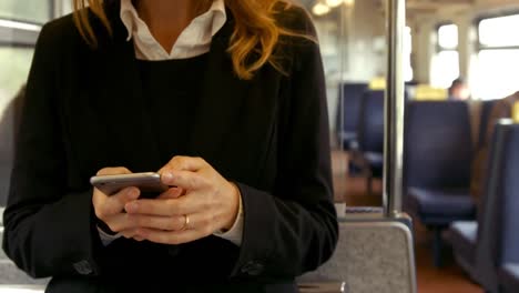 businesswoman using phone on the train