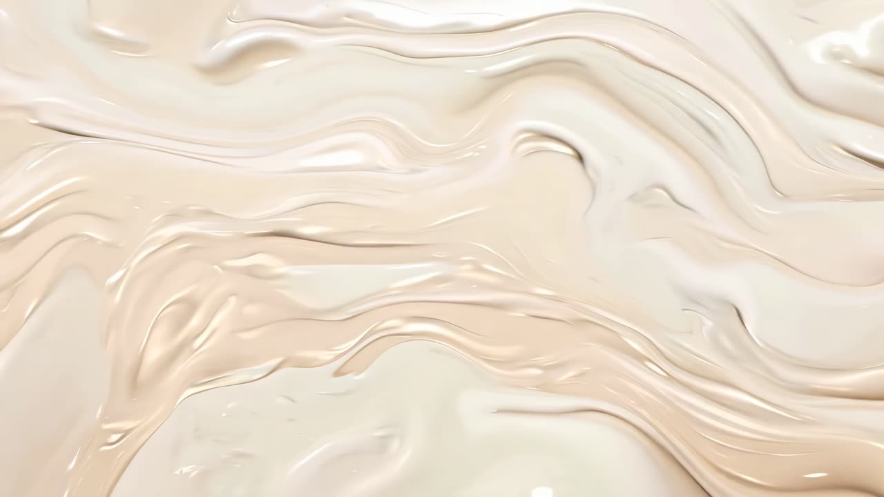 Abstract video with a top-down angle showcasing smooth, flowing beige and cream textures