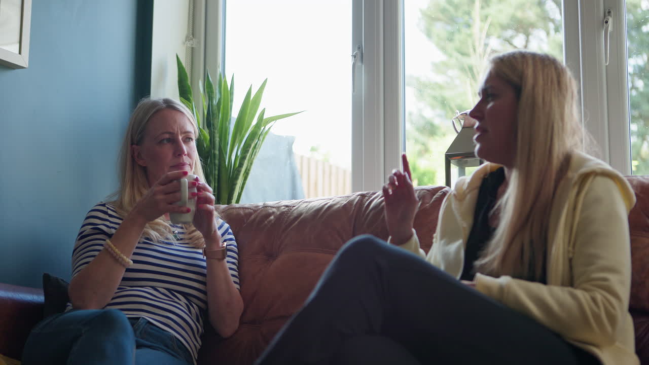 Duas mulheres conversando em um ambiente interno