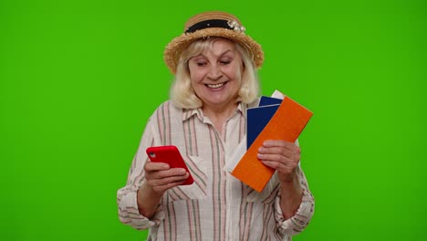 mature woman traveler tourist browsing on mobile phone and looking for holiday resort vacation trip