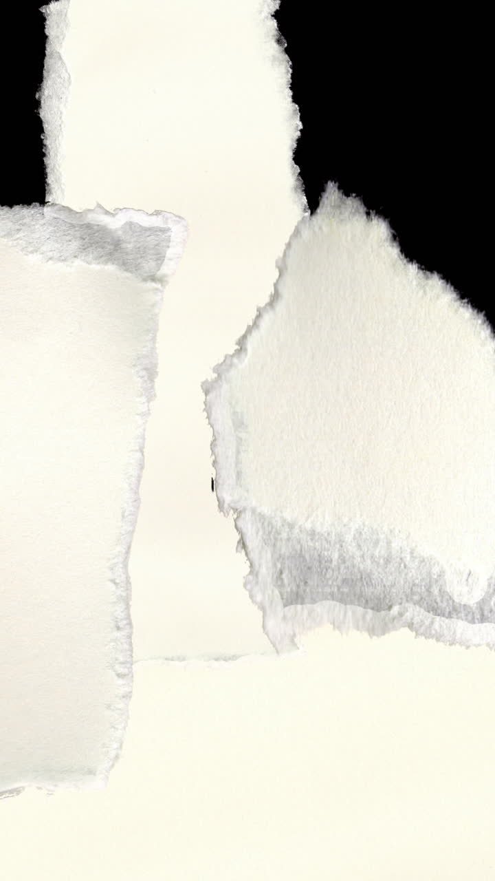 Animated Torn Paper Pieces Appearing on Black Background