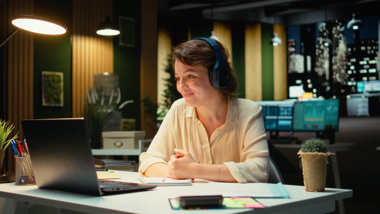 Vertical Video Focused consultant takes notes during executive board meeting video call