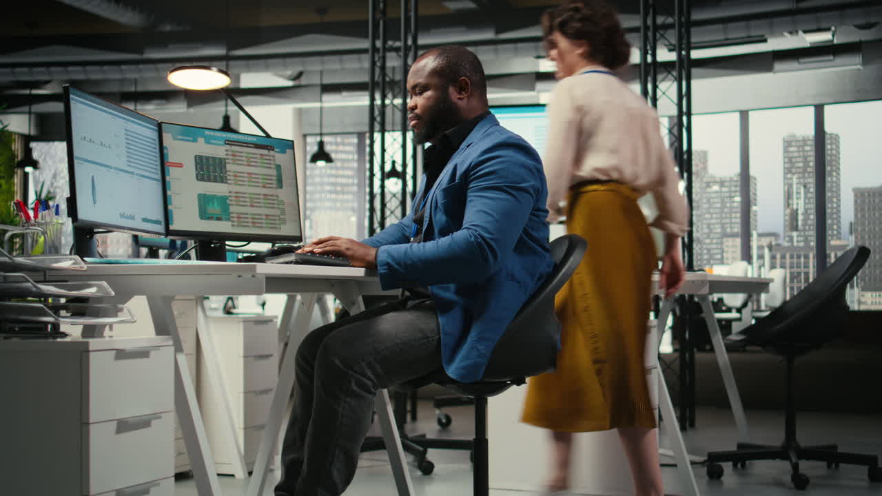 Vertical Video Black male analyst focused on IT company development with digital tools