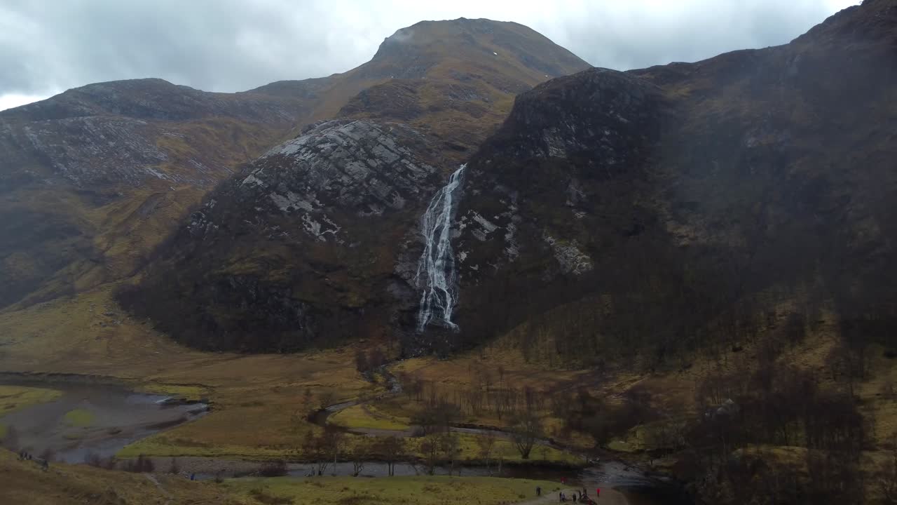 Aerial view of majestic Steall Falls in Nevis Gorge in dramatic weather with rain - Scotland