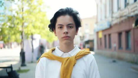 teenage boy portrait on city street