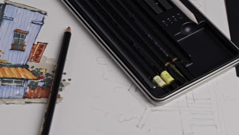 top down pan of an architectural sketch and drawing pencils