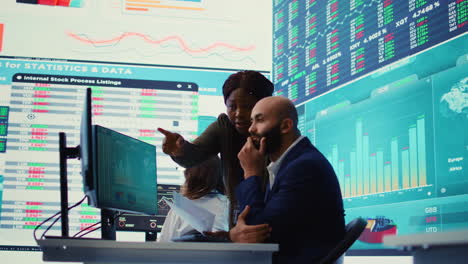 diverse business analysts working to evaluate costs and create a projection