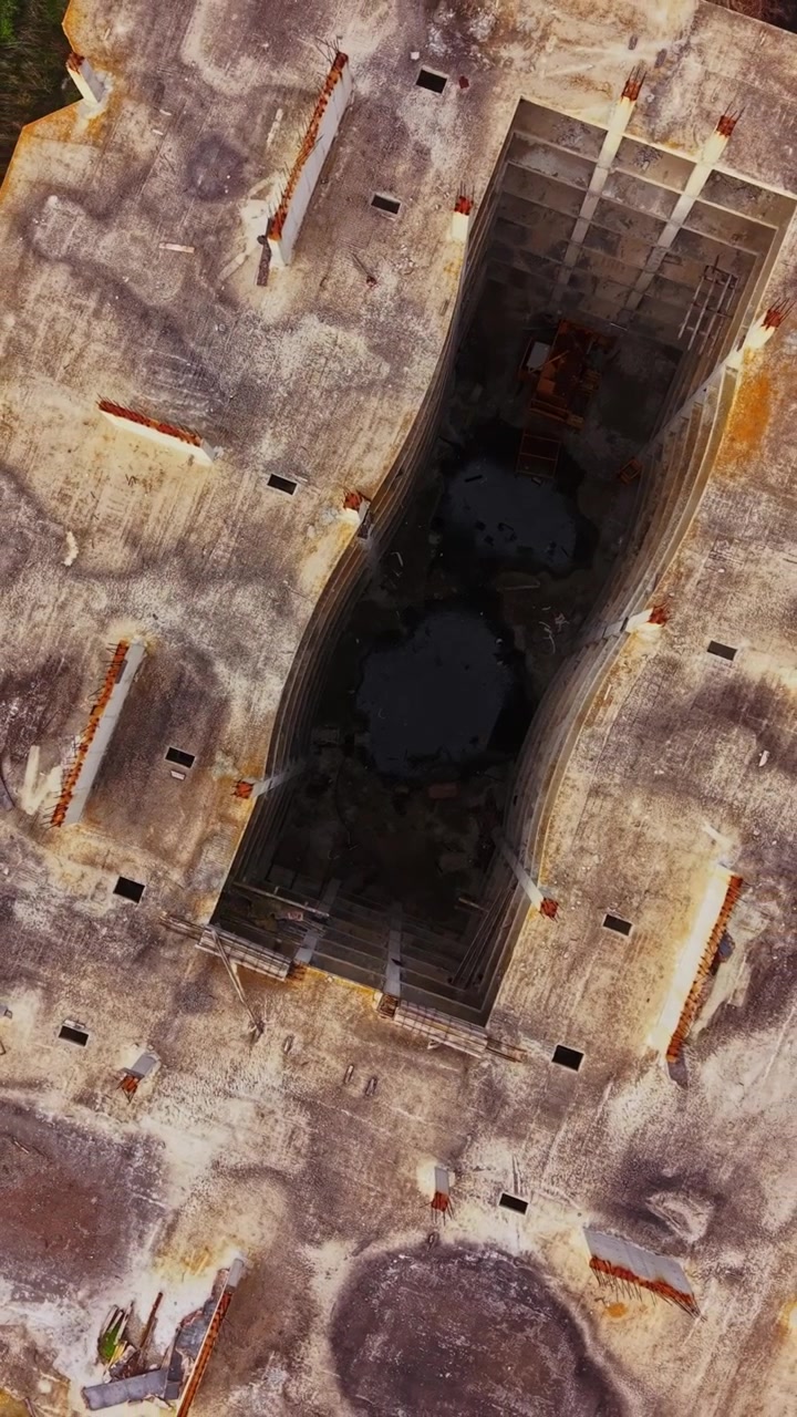 Aerial view of a construction site revealing deep excavation work