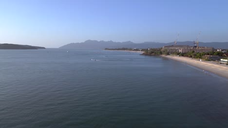 Langkawi-coastline-showing-hotels-and-resorts-on-a-tropical-beach-with-tourists-enjoying-the-clear-blue-water