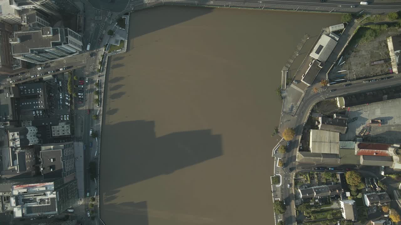 Limerick city and shannon river with morning sunlight casting long shadows, aerial view