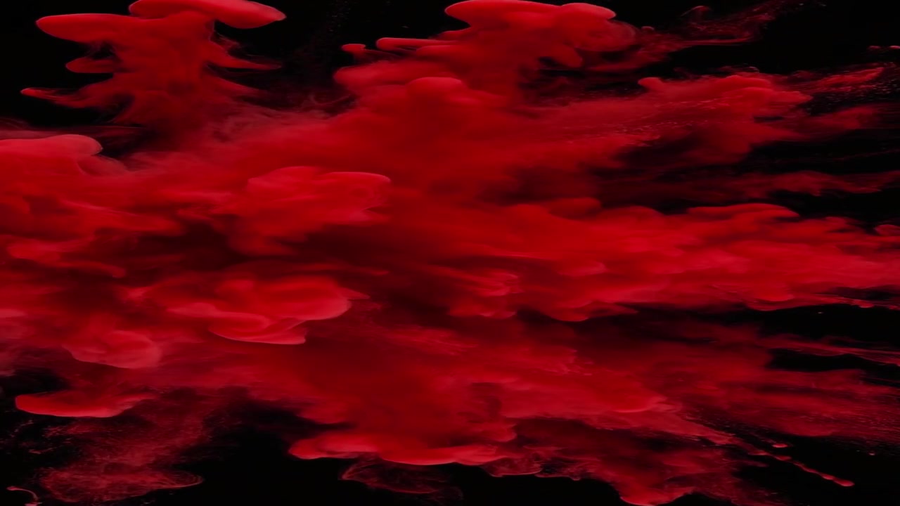 Red Powder Explosion Against Black Background