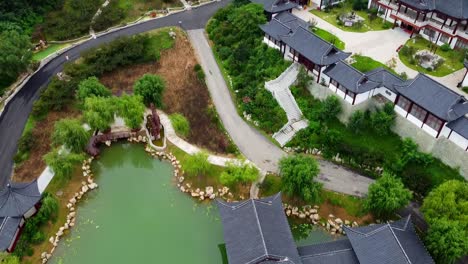 aerial revealing stunning landscape and traditional chinese zen architecture temple in huaxiacheng theme park weihai china