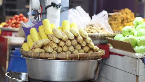 steaming corn cobs in a bustling market scene