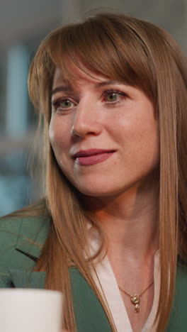 loving wife smiles looking at husband drinking water in cup to swallow pill. woman enjoys taking care of man helping to overcome disease closeup