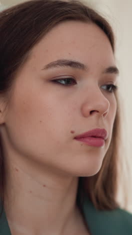 indifferent woman with emotional burnout at home closeup. frustrated lady handles with trauma symptoms staying in apartment. care of mental health