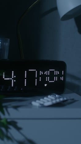 nightstand with clock and medication