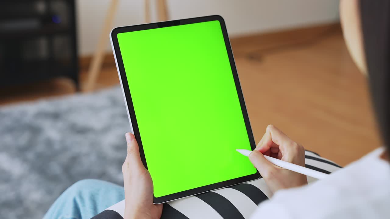 close up de mujer sosteniendo en las manos una tableta digital con pantalla verde para internet en línea, pantalla clave de croma para publicidad.