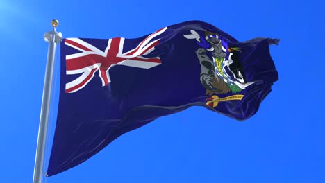 bandera de georgia del sur y las islas sandwich del sur ondeando al viento en lento con cielo azul, bucle