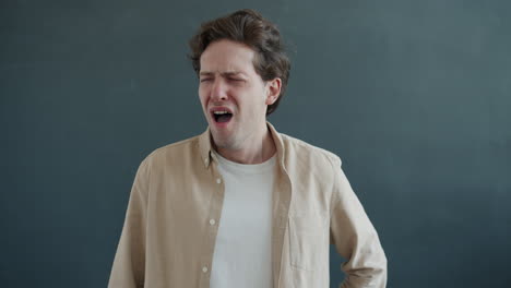 man yawning and praying