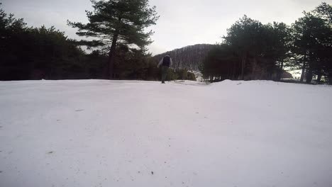 Man-walking-away-in-a-frost-path