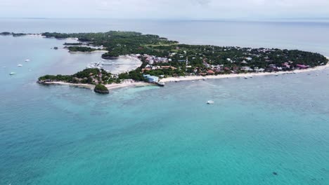 wide aerial shot of malapascua island or logon with dive resorts on long bounty beach, philippines