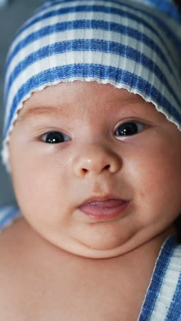 baby with striped hat