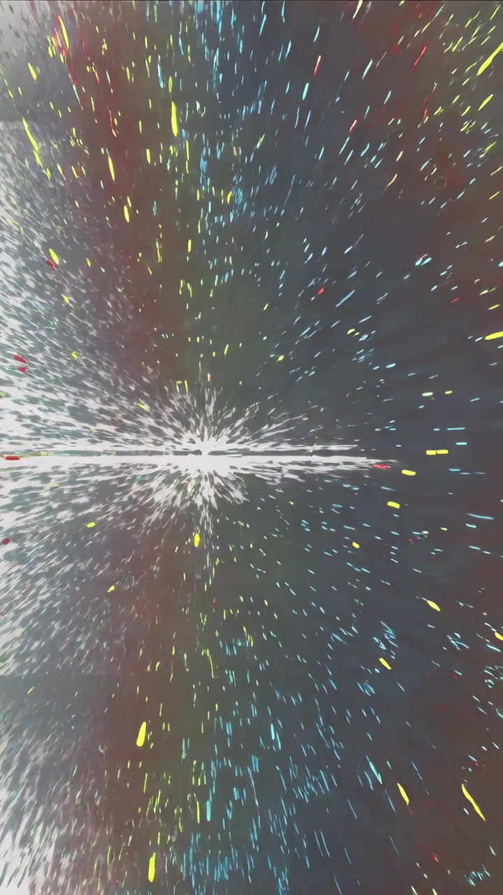 Vertical video: Breaking striped panel sending confetti specks across pale wall, making color burst