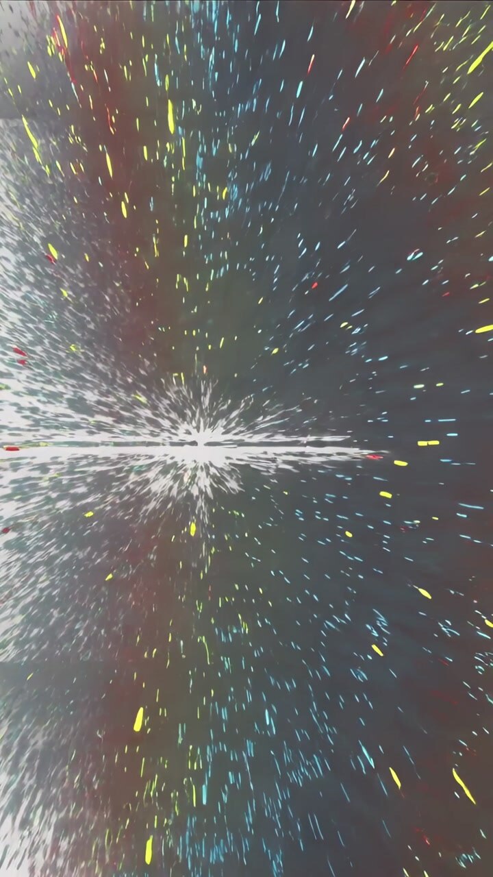 Vertical video: Breaking striped panel sending confetti specks across pale wall, making color burst