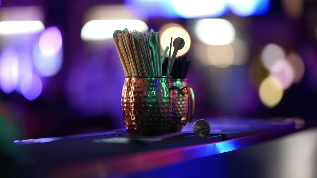 Nightclub Bartender Accessories with Dancefloor Lights and Bokeh Background