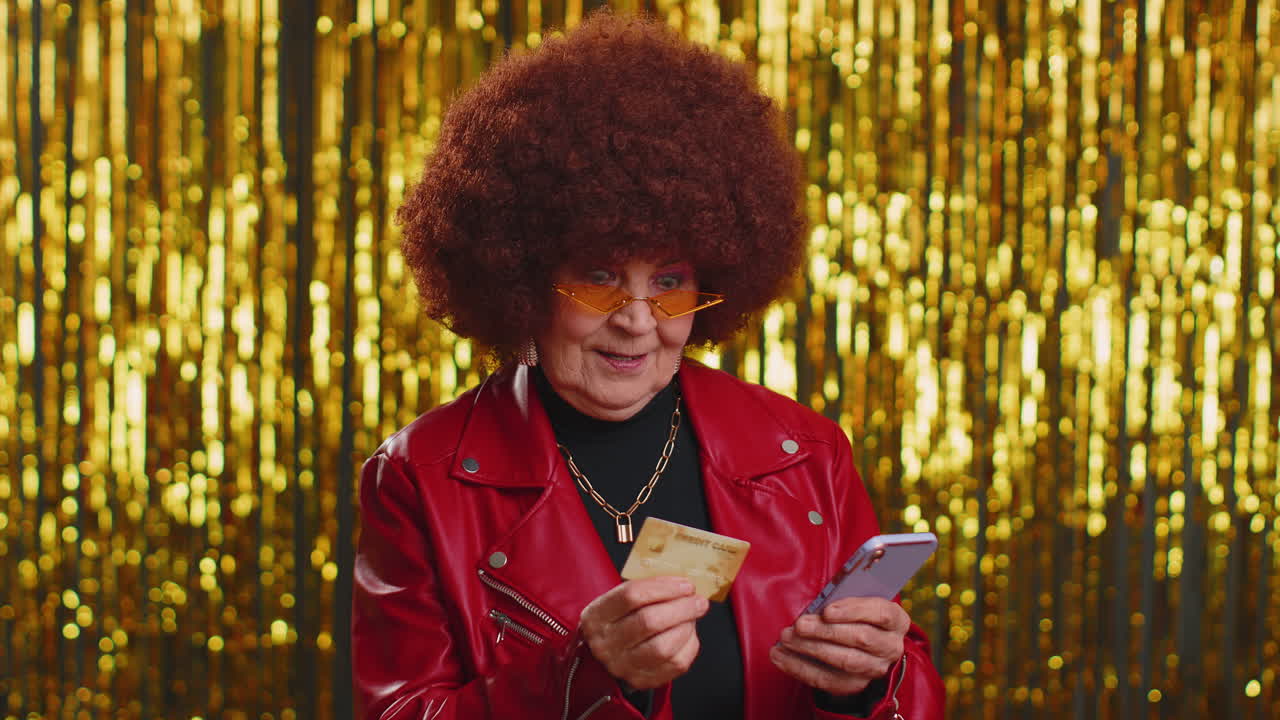 Senior woman using credit bank card smartphone while transferring money, purchases online shopping