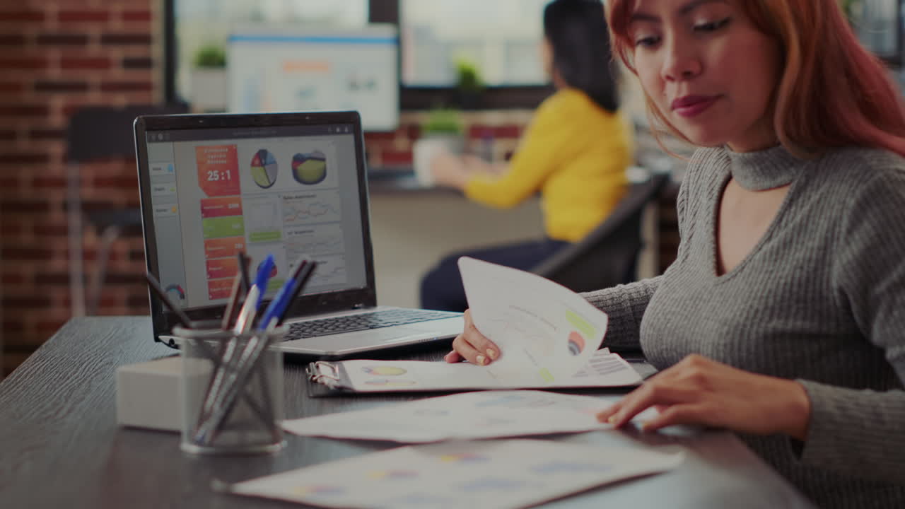 Asian woman working on e commerce growth in business office