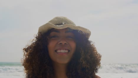 Front-view-of-African-american-woman-standing-on-the-beach-4k