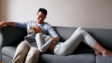 couple relaxing on sofa