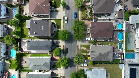 Aerial-top-down-shot-of-luxury-American-neighborhood-with-swimming-pools-in-garden---top-view-flyover