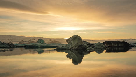 fiery sunset over jokulsarlon glacier lagoon in south iceland with reflection on water. - static shot  - timelapse