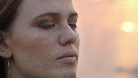close-up-portrait-beautiful-red-head-woman-opening-eyes-meditating-at-sunset-praying-exploring-spiritual-lifestyle-enjoying-mindfulness