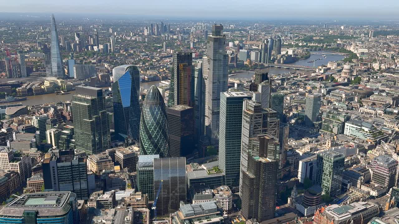 Wide aerial view of the City of London towers with the River Thames and the Shard behind. London, UK.