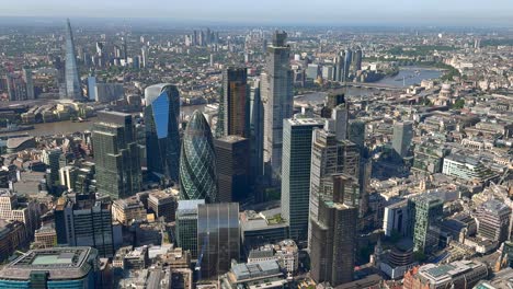 wide aerial view of the city of london towers with the river thames and the shard behind. london, uk.