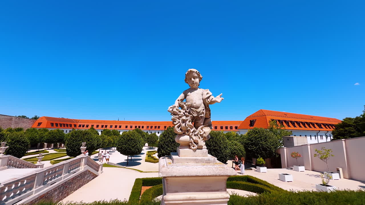 Bratislava, Slovakia, 2 June 2025: Adorable sculpture of a young child in the beautiful garden. Amorino image near the Bratislava Castle in Slovakia