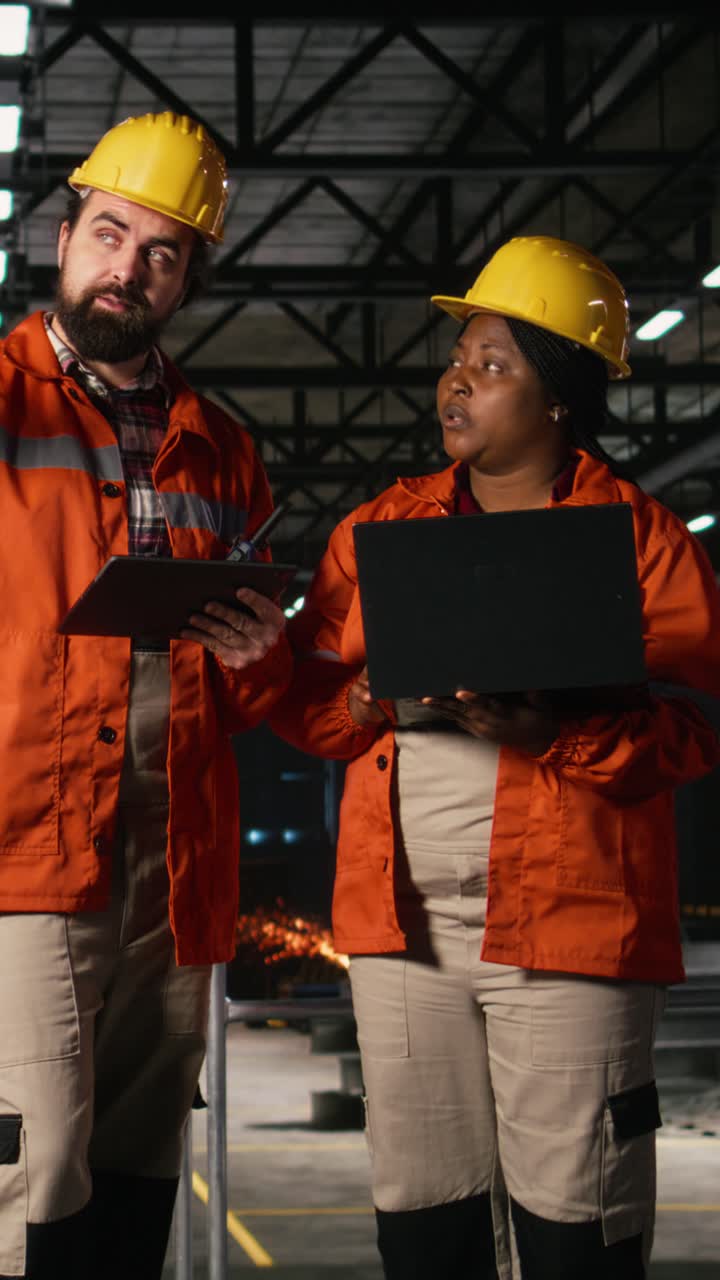 Vertical Video Engineering team reviewing steel work and heavy equipment in industrial space