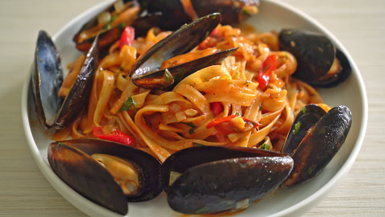 Spaghetti con cozze o vongole e salsa di pomodoro - Italian food style