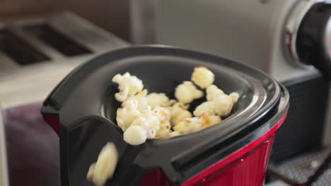 popcorn kernel popping out of air machine and flying everywhere