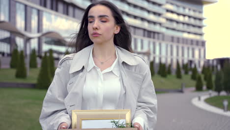 close up of a pretty woman walking in front of an office building 1