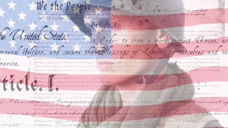 Digital composite video of us constitution text against waving us flag and american soldier