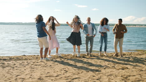 friends dancing on the beach