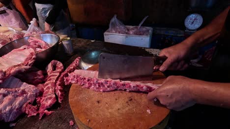 butcher cuts ribs with precision and speed.