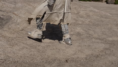 fantasy warrior hiking in a desert landscape